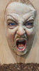 Zoom into a sculpture of a man with his mouth open