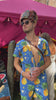 Person at a festival wearing a unique hat and Pineapple outfit