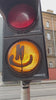 Street light with a graffitied face