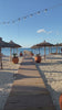 Walking along a pier on sandy beach with sea view, Albania